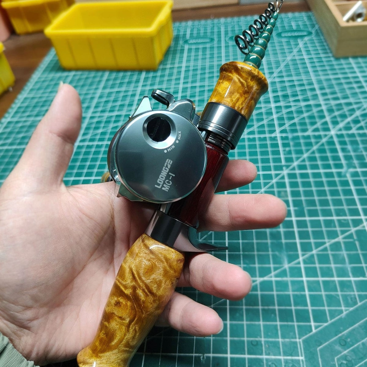 Atelier Contour held with a casting reel mounted, illustrating a compact setup; reel not included.