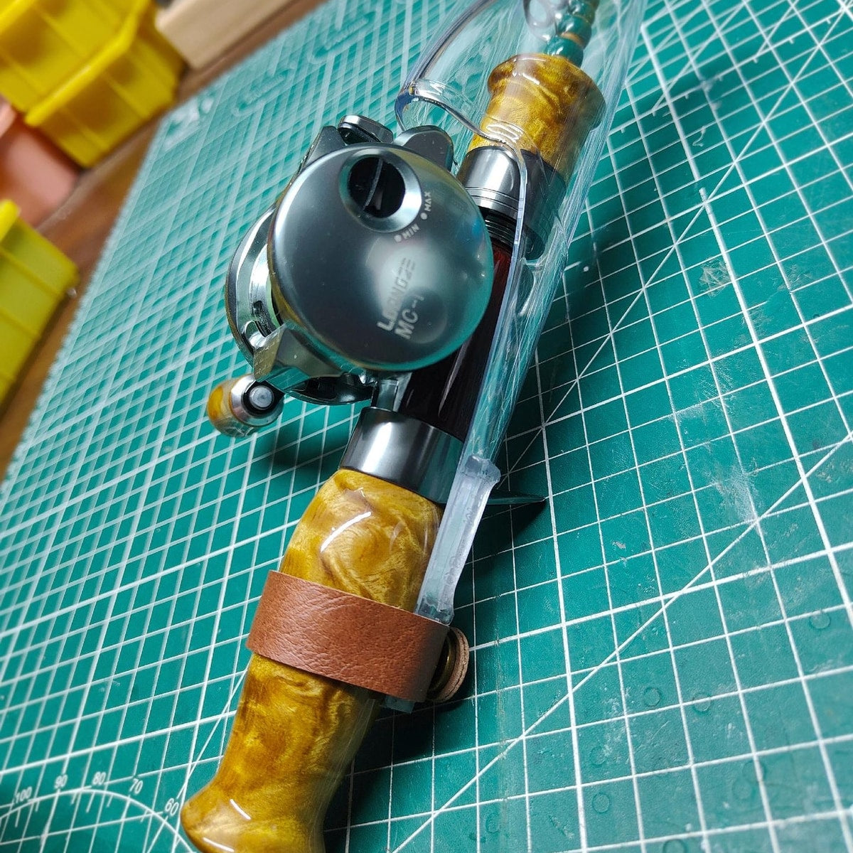 Close-up of Atelier Contour with a protective cover and a casting reel mounted for a packed-setup example; reel not included.