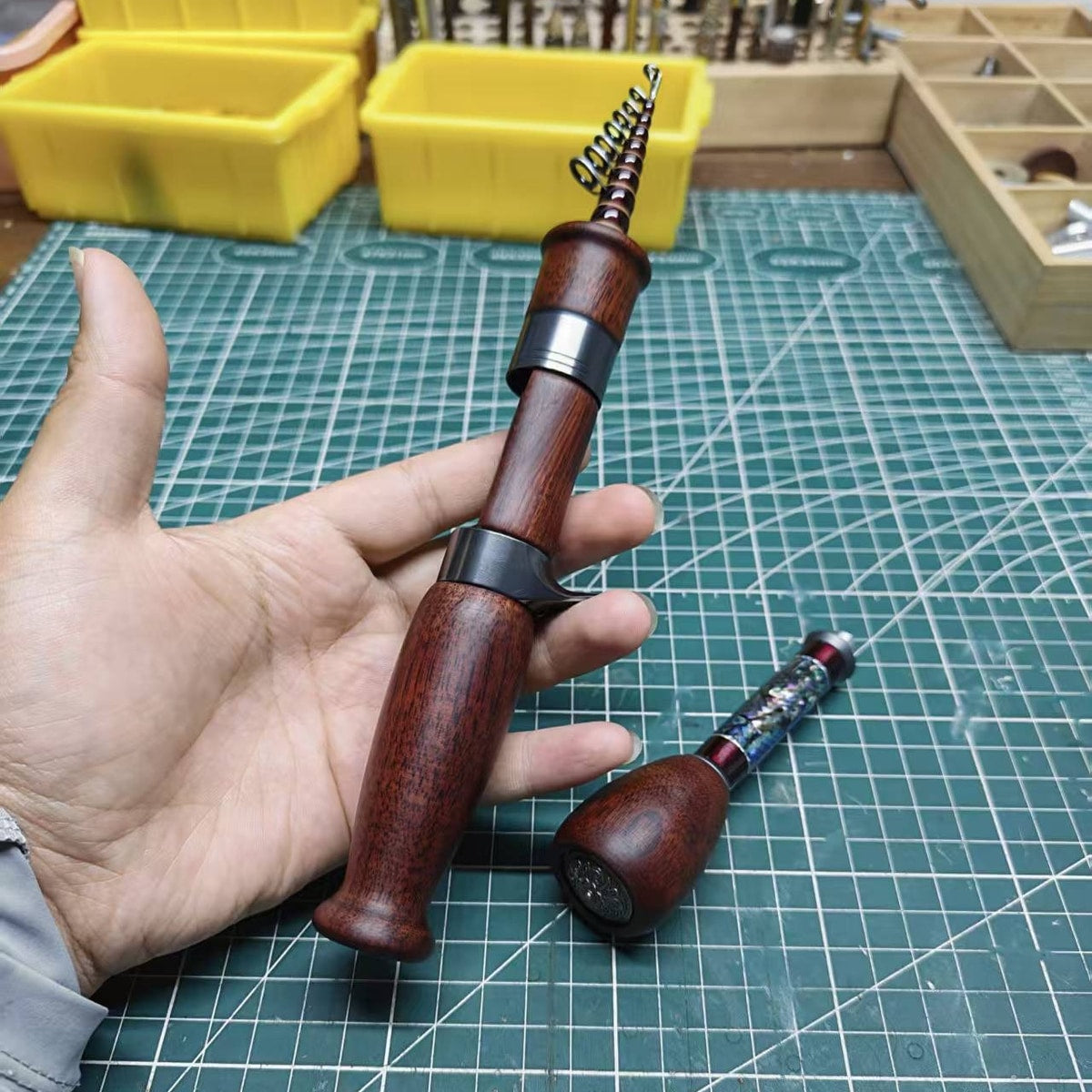 Dark-wood Atelier Contour reference build with the removable rear extension placed beside the standard grip.