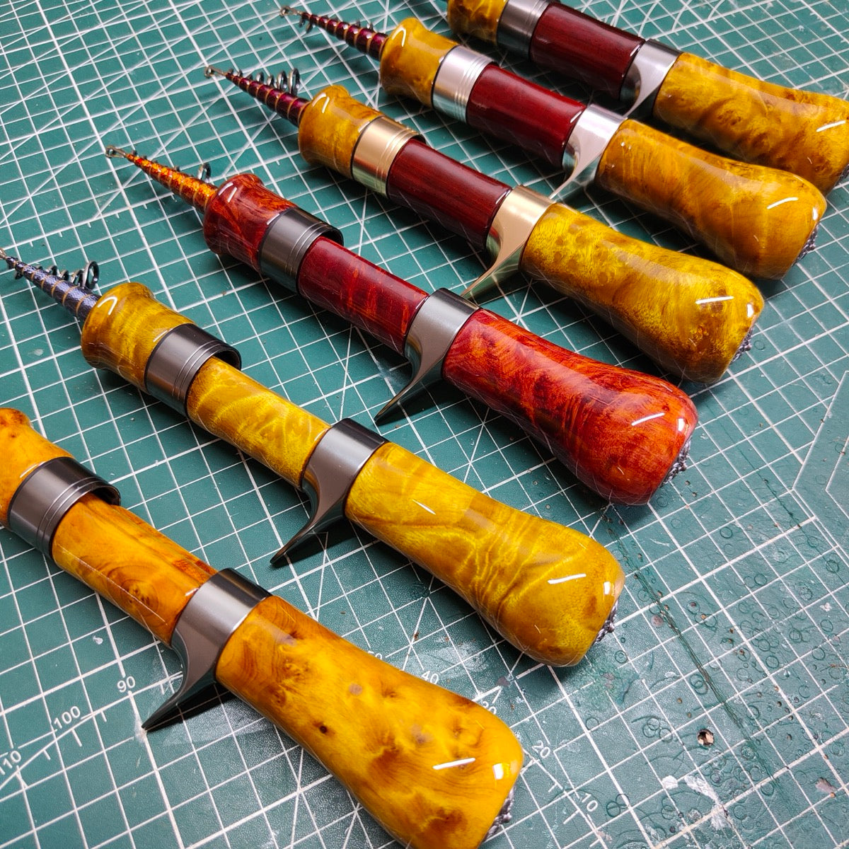 Example custom telescopic casting rods with wood handles. Each rod is sold separately; configuration and grain vary.