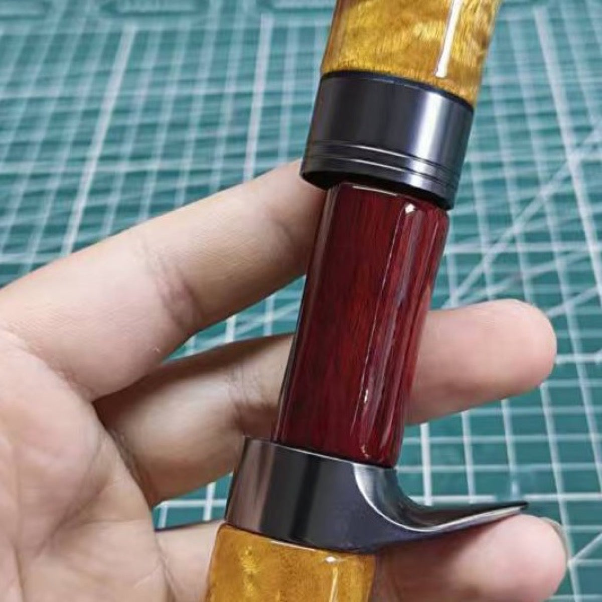 Red Ketan wood used only for the middle reel-seat insert, shown with a golden-toned handle.