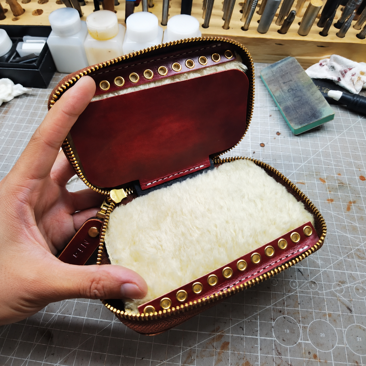 Open leather lure wallet with wool lining, divider and brass eyelets
