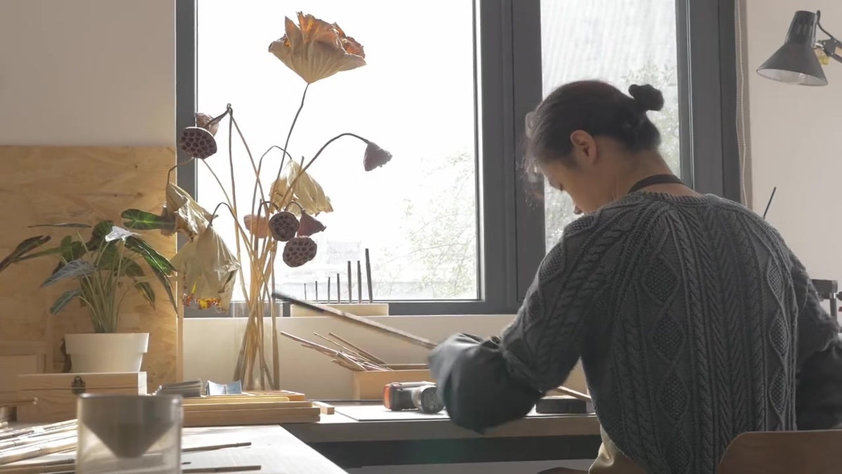 Craftsperson working with handmade fishing gear and natural materials at the JFL Workshop