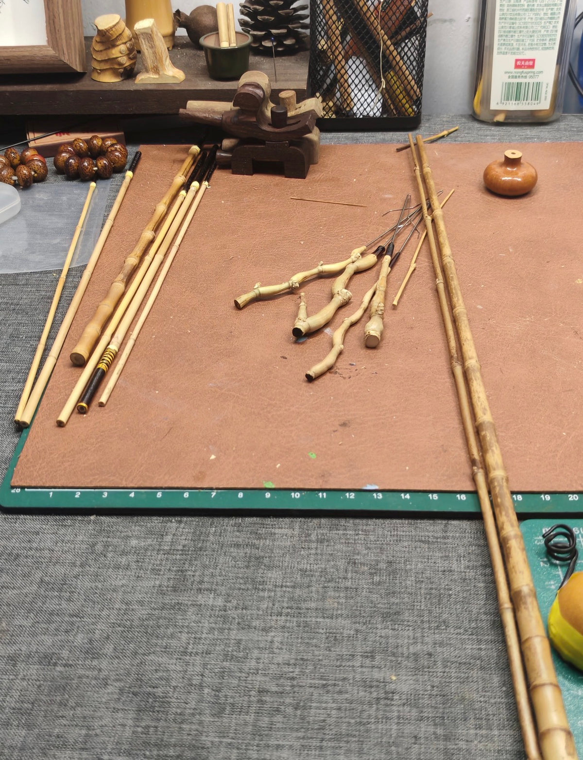 Raw bamboo, unfinished components, fine tools, and completed pieces on the JFL Workshop bench