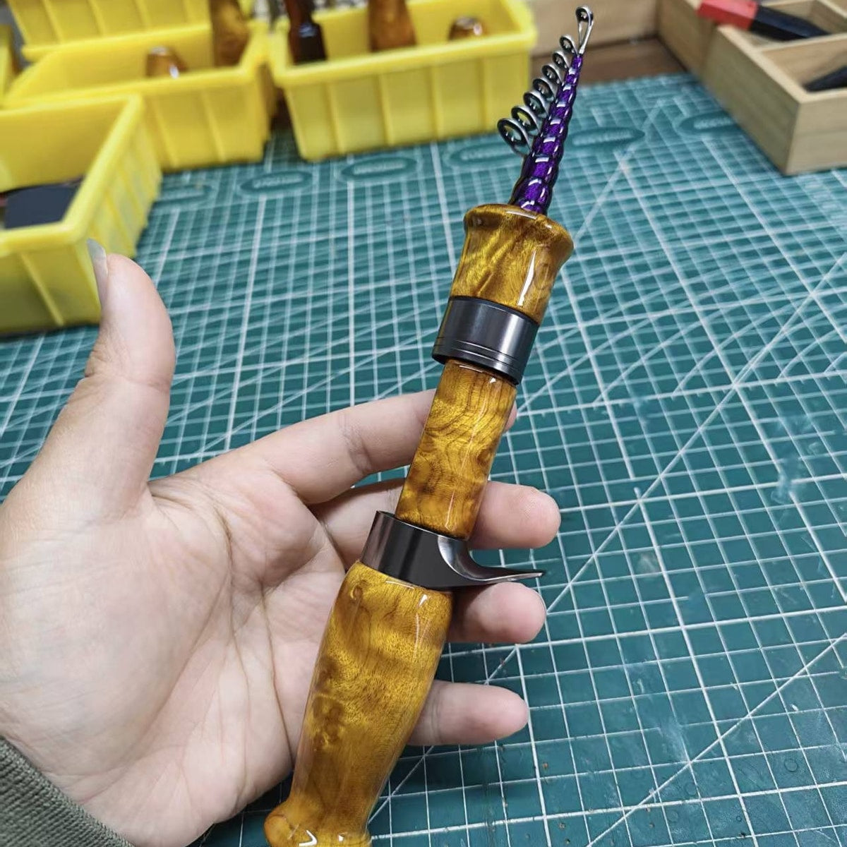 Atelier Contour reference build with a golden-toned sculpted grip, dark hardware and purple guide wrapping.
